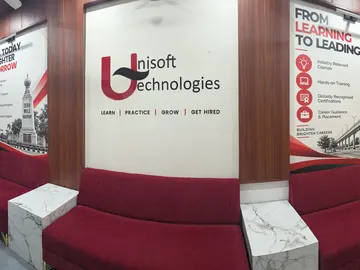 The new reception at Unisoft Technologies, Dharampeth, Nagpur: the logo wall, two posters and red sofas
